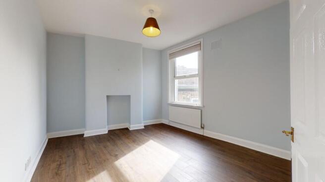 Bright and spacious master bedroom featuring so...