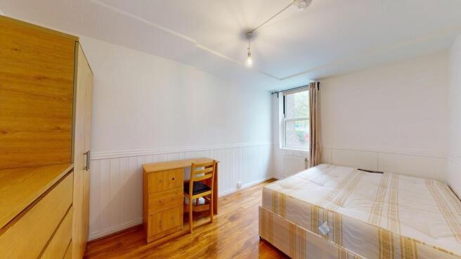 Bright and tidy bedroom featuring a double bed,...