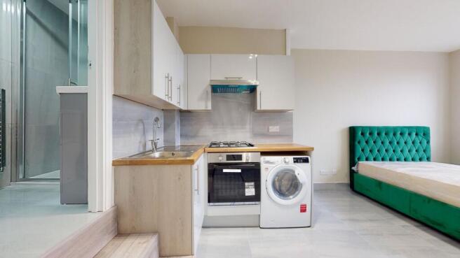 Modern kitchen with a compact layout featuring ...