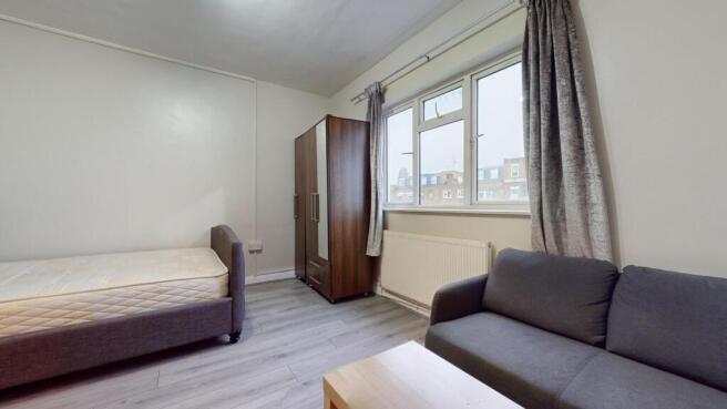 A neat single bedroom featuring a comfortable b...