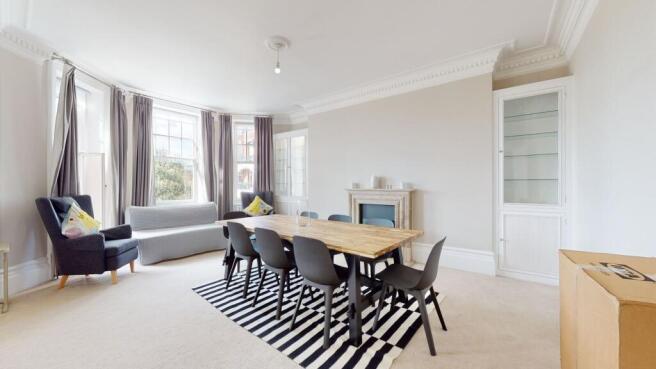 A bright and spacious living room featuring a l...