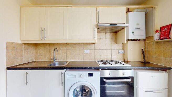 A well-organized kitchen featuring cream cabine...