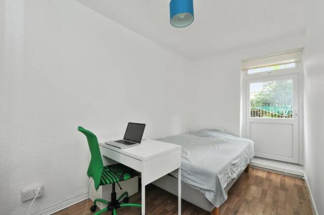 A clean and simple double bedroom featuring a w...