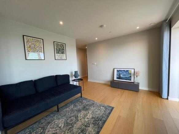 Bright, modern living area with wood flooring, ...