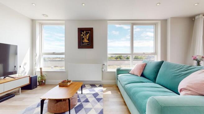 Bright, modern living room with large windows, ...