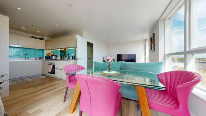 Bright, modern open-plan living area with full-...