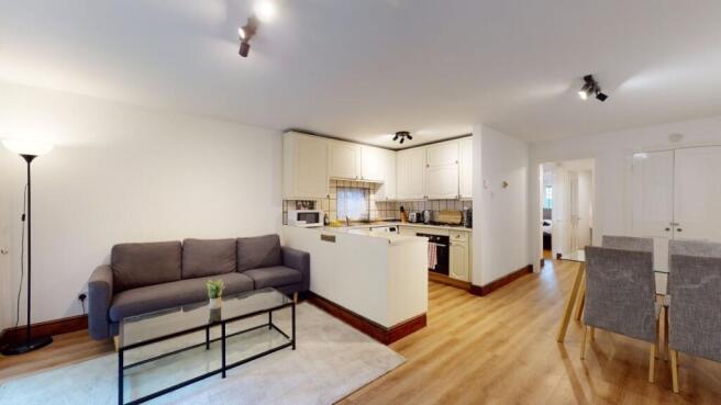 Bright open-plan living and kitchen area with m...
