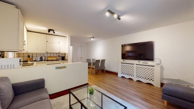 Bright, modern open-plan living area with a com...