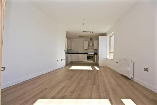 Bright open-plan living area with modern fitted...