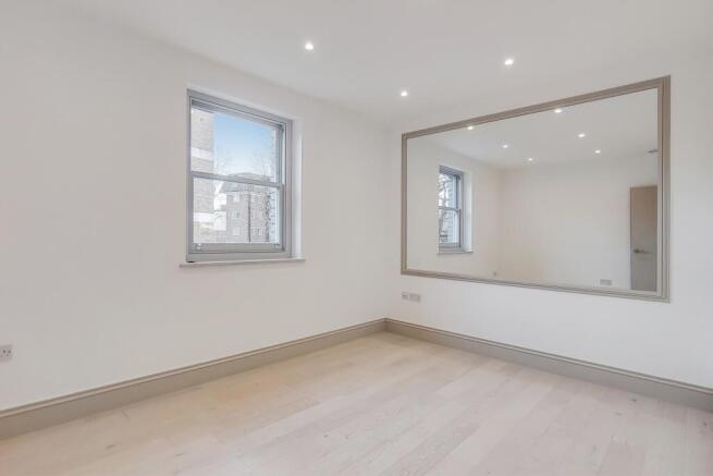 Bright, newly finished bedroom with light wood ...