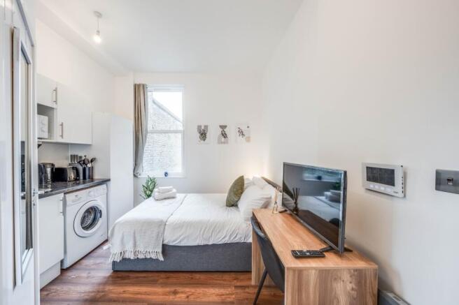 This inviting double bedroom features a cozy be...