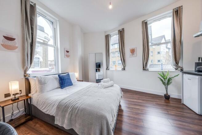 Bright and inviting double bedroom featuring la...