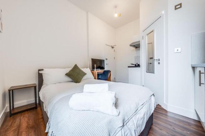 This inviting double bedroom features a cozy be...
