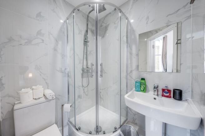Stylish bathroom featuring a modern shower encl...