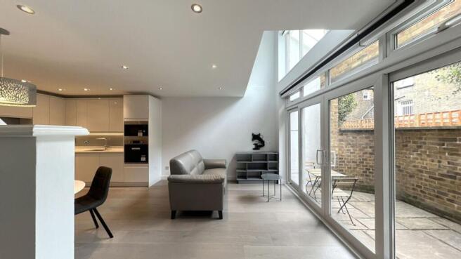 Bright and spacious living room with large wind...