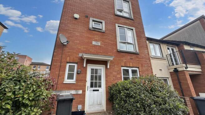 Front view of a well-maintained red brick prope...