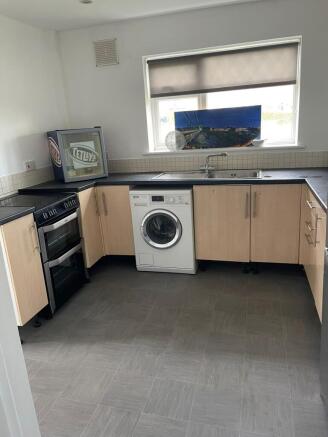 A tidy kitchen featuring essential appliances, ...