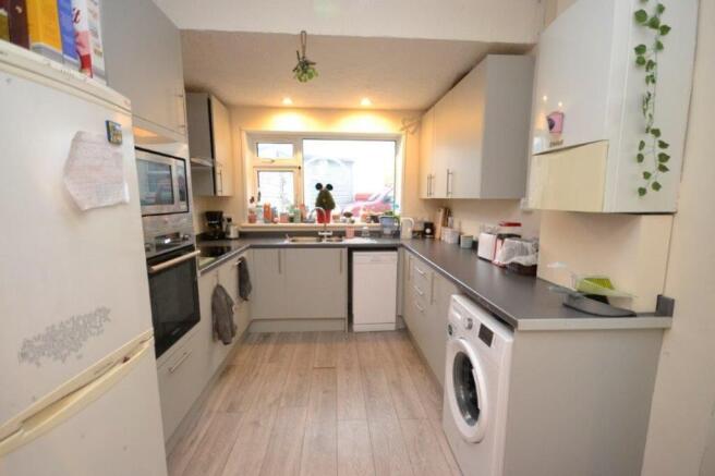 A tidy and well-lit kitchen featuring modern ap...