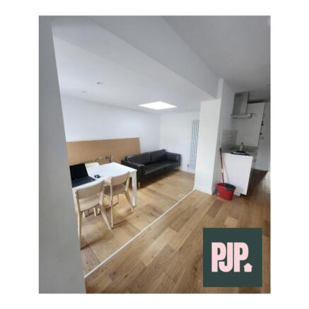 A spacious and well-lit modern living room perf...