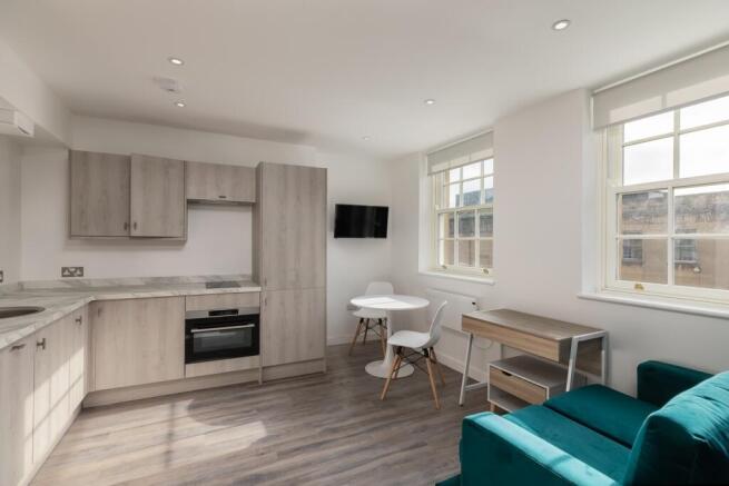 A modern and bright kitchenette featuring styli...