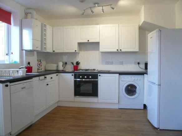 A bright and spacious kitchen featuring modern ...