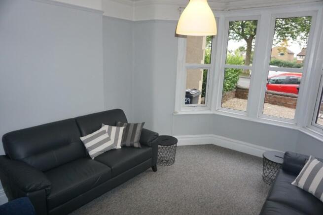 A stylish and bright modern living room with am...