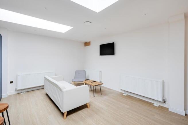 A bright and clean living room featuring modern...
