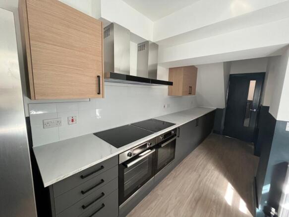 A modern and spacious kitchen featuring ample s...