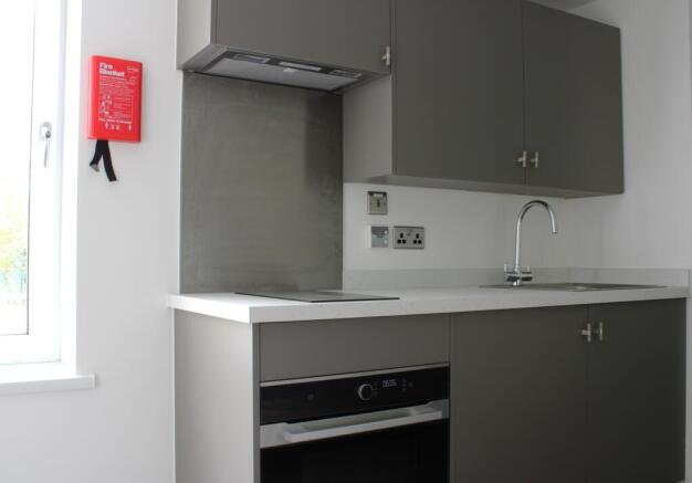 A modern kitchenette with sleek cabinetry and a...