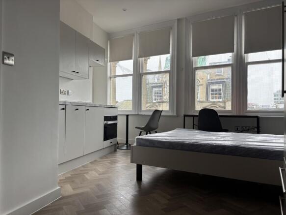 A spacious and bright double bedroom featuring ...