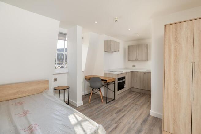A modern and spacious kitchenette area with amp...