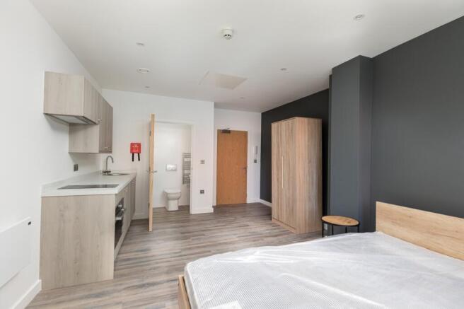 A spacious and well-lit double bedroom featurin...