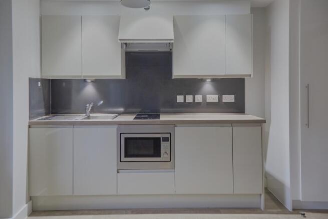 A modern kitchenette with sleek cabinetry and a...