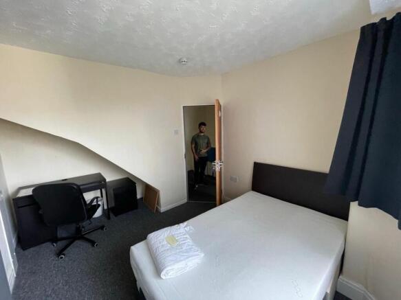 Cozy double bedroom featuring a comfortable bed...