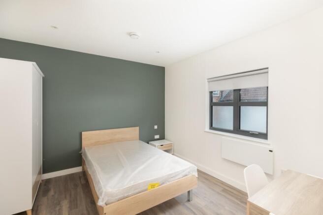 A bright and modern double bedroom featuring a ...