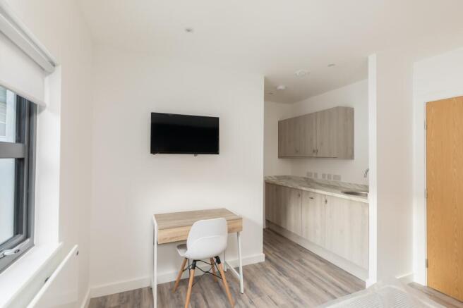 A bright and modern kitchenette with stylish ca...