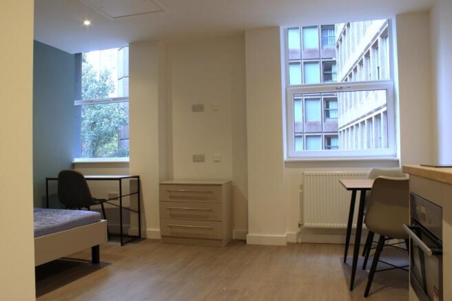 A bright and tidy double bedroom featuring ampl...