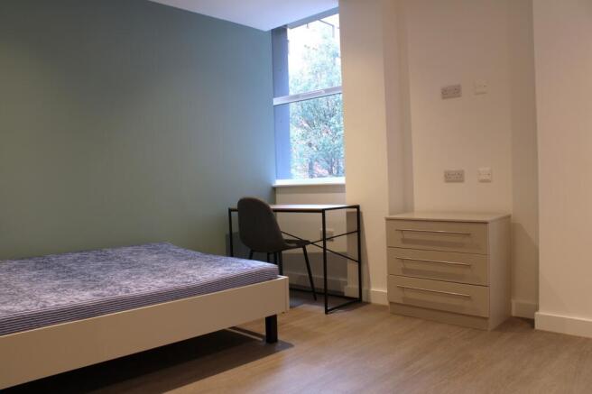 A bright and modern double bedroom featuring a ...