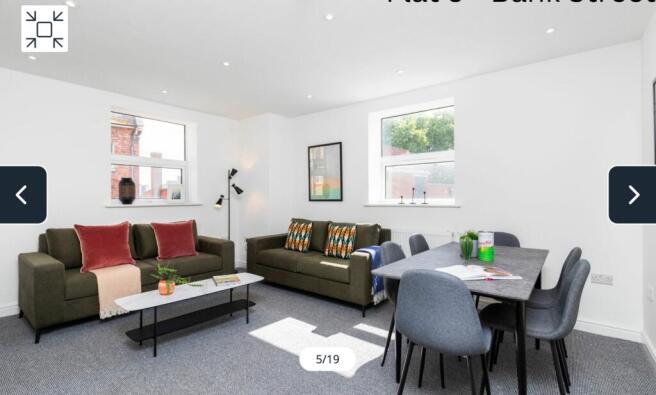 A spacious and inviting modern living room, per...