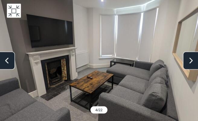 A spacious and inviting modern living room, per...
