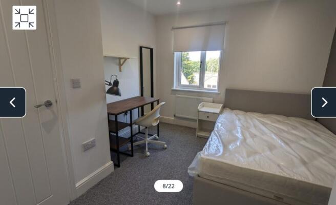 A bright and spacious double bedroom with moder...