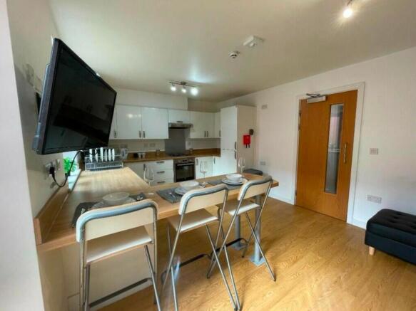 A modern and spacious kitchenette with ample na...