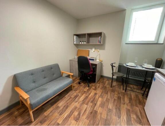 A tidy and inviting living room with a cozy sof...