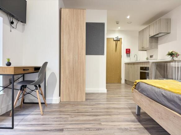 A spacious and well-lit double bedroom with mod...