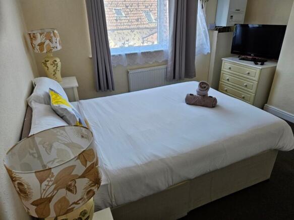 A bright and inviting double bedroom with taste...