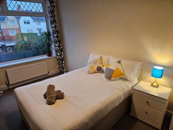 A bright and inviting double bedroom featuring ...