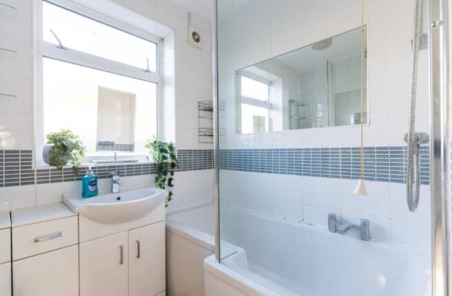 A bright and modern bathroom featuring a spacio...