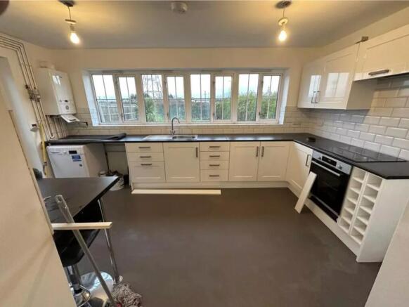 A bright and spacious kitchen with modern fitti...