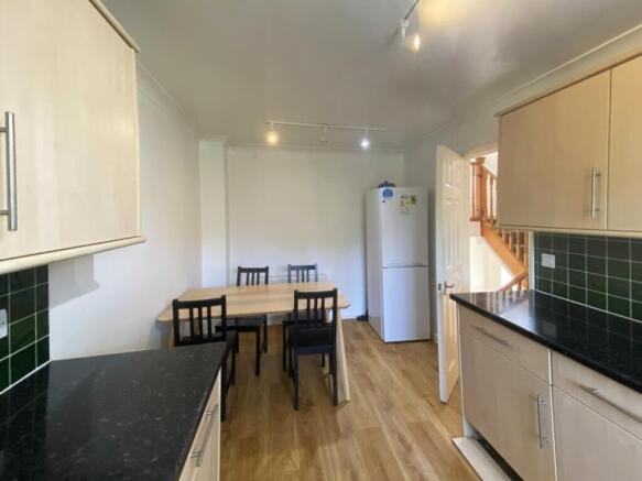 A spacious and bright kitchen area with modern ...