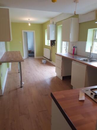A spacious and well-lit kitchen featuring moder...